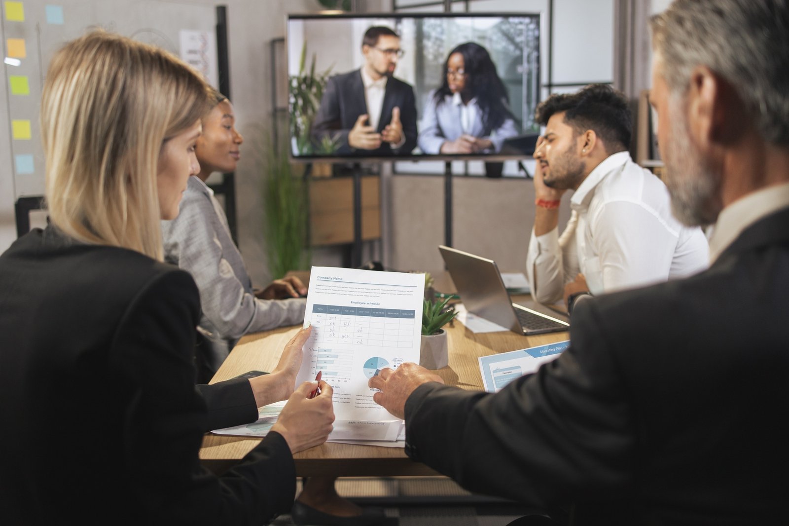 Close up cropped shot of experienced multiethnic businesspeople, analyzing financial report